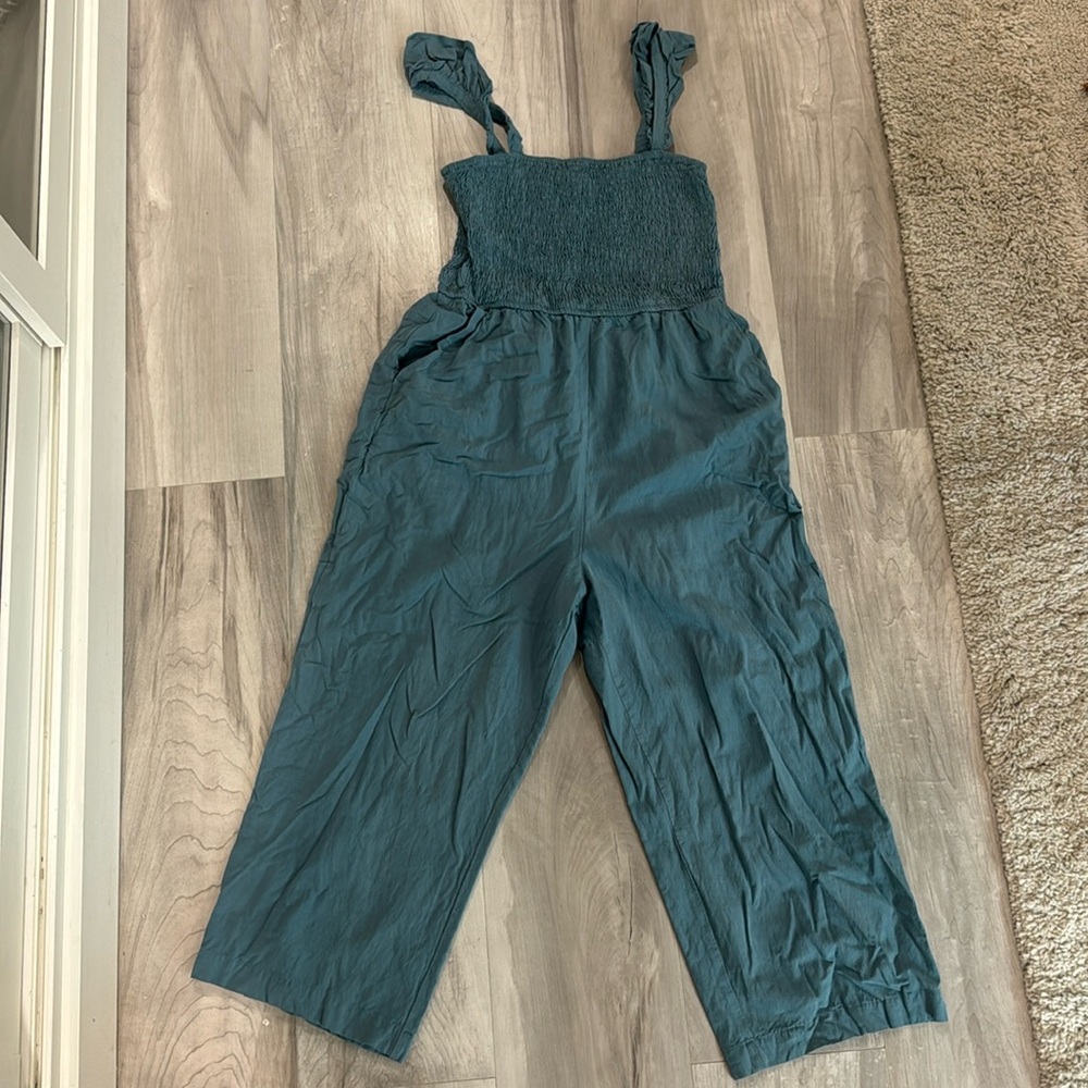 Blue cropped jumpsuit with smocked top and ruffle straps and pockets